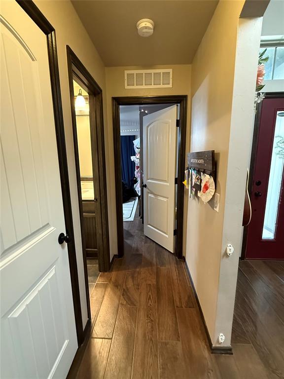 18641 Como Dr, Edmond, OK 73012 - hall with dark wood finished floors and arched walkways