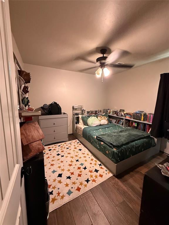 18641 Como Dr, Edmond, OK 73012 - bedroom with wood finished floors and a ceiling fan