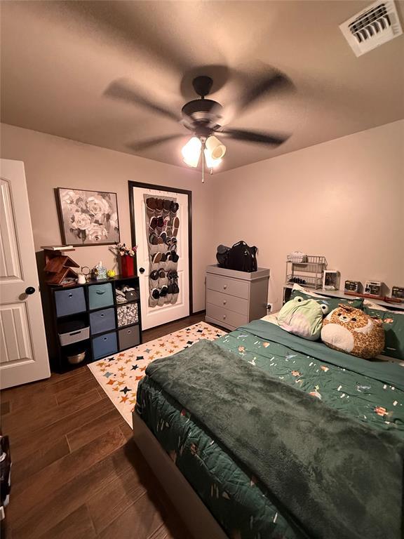 18641 Como Dr, Edmond, OK 73012 - bedroom featuring wood finished floors and a ceiling fan