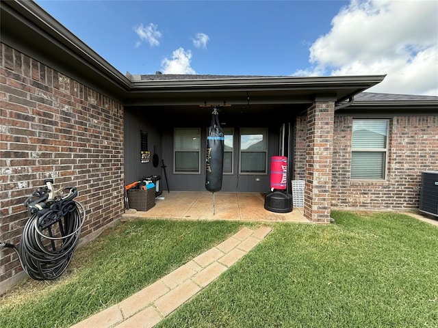18641 Como Dr, Edmond, OK 73012 - doorway to property featuring a yard and brick siding