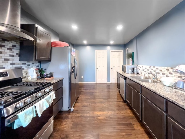 223 SE 53rd St, Oklahoma City, OK 73129 - kitchen featuring appliances with stainless steel finishes, wall chimney exhaust hood, backsplash, dark brown cabinetry, and dark wood-style flooring