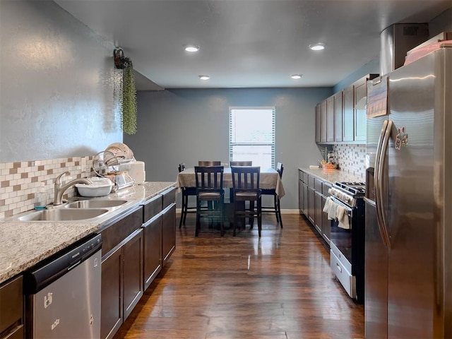 223 SE 53rd St, Oklahoma City, OK 73129 - kitchen with stainless steel appliances, decorative backsplash, light countertops, dark wood-style floors, and dark brown cabinetry