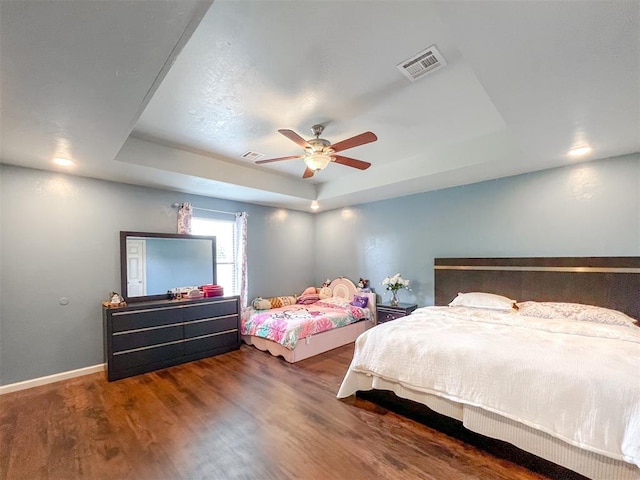 223 SE 53rd St, Oklahoma City, OK 73129 - bedroom featuring a tray ceiling, wood finished floors, and ceiling fan