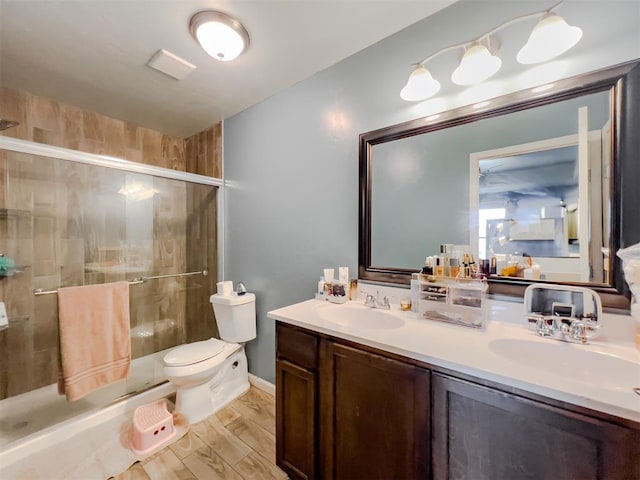 223 SE 53rd St, Oklahoma City, OK 73129 - full bathroom featuring double vanity, a shower stall, and wood finished floors