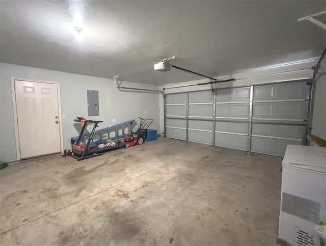 223 SE 53rd St, Oklahoma City, OK 73129 - garage with electric panel, refrigerator, and a garage door opener