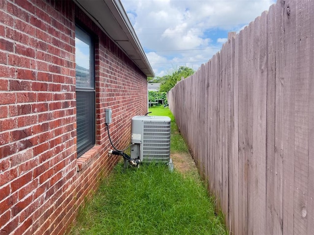 223 SE 53rd St, Oklahoma City, OK 73129 - view of property exterior featuring a central AC unit and brick siding