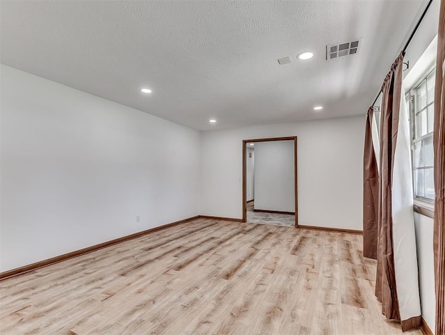 4325 NW 44th St, Oklahoma City, OK 73112 - empty room featuring light wood-style floors, recessed lighting, and a textured ceiling