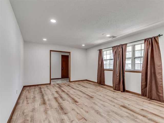 4325 NW 44th St, Oklahoma City, OK 73112 - unfurnished room with light wood-style flooring, recessed lighting, and a textured ceiling