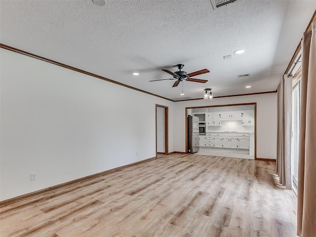 4325 NW 44th St, Oklahoma City, OK 73112 - unfurnished living room featuring ornamental molding, a ceiling fan, light wood finished floors, recessed lighting, and a textured ceiling