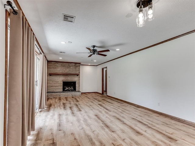 4325 NW 44th St, Oklahoma City, OK 73112 - unfurnished living room featuring light wood finished floors, ceiling fan, a stone fireplace, a textured ceiling, and recessed lighting