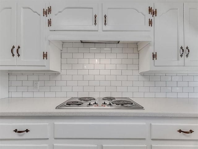 4325 NW 44th St, Oklahoma City, OK 73112 - kitchen with white cabinets, light countertops, stainless steel electric cooktop, and backsplash