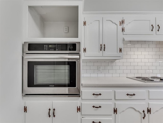 4325 NW 44th St, Oklahoma City, OK 73112 - kitchen with stainless steel appliances, white cabinetry, backsplash, and light countertops
