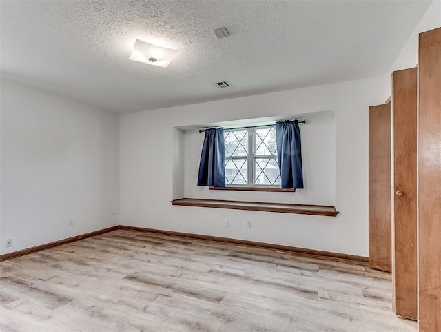 4325 NW 44th St, Oklahoma City, OK 73112 - unfurnished room featuring wood finished floors and a textured ceiling