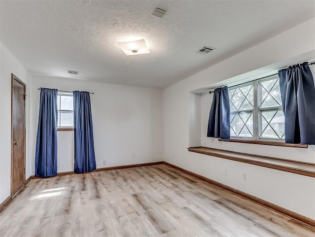 4325 NW 44th St, Oklahoma City, OK 73112 - empty room featuring light wood-style floors and a textured ceiling