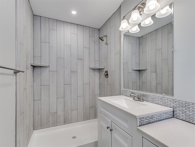4325 NW 44th St, Oklahoma City, OK 73112 - full bathroom featuring tiled shower, vanity, a chandelier, and tasteful backsplash