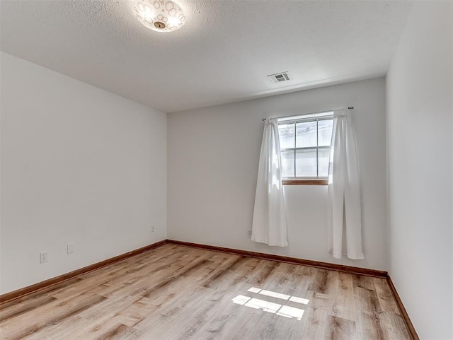 4325 NW 44th St, Oklahoma City, OK 73112 - spare room featuring light wood finished floors and a textured ceiling