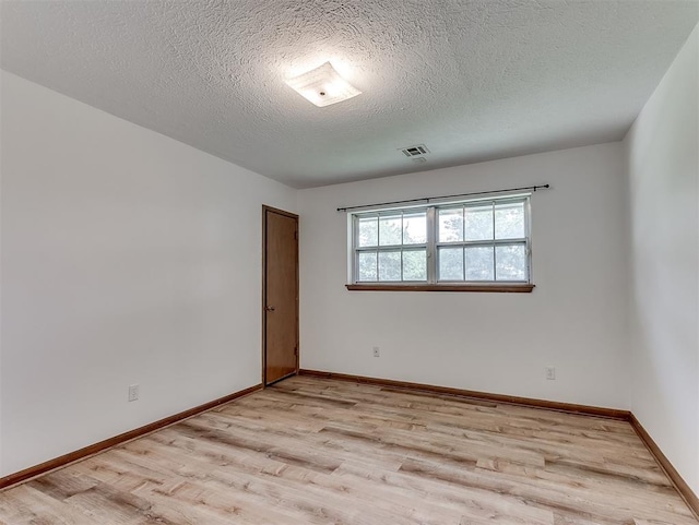 4325 NW 44th St, Oklahoma City, OK 73112 - empty room featuring light wood-type flooring and a textured ceiling