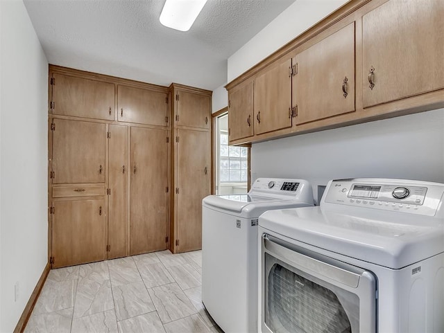 4325 NW 44th St, Oklahoma City, OK 73112 - laundry room with cabinet space, washer and clothes dryer, light marble finish flooring, and a textured ceiling