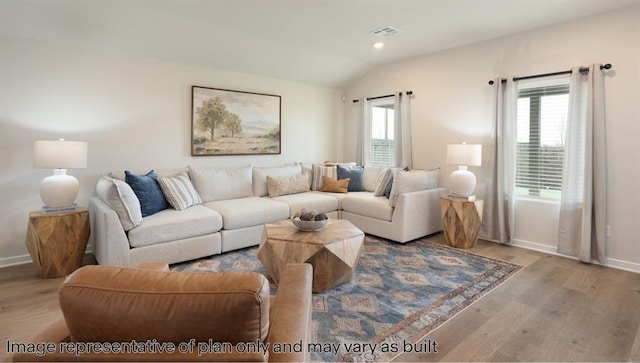 10201 NW 28th Ter, Yukon, OK 73099 - living room featuring wood finished floors and vaulted ceiling