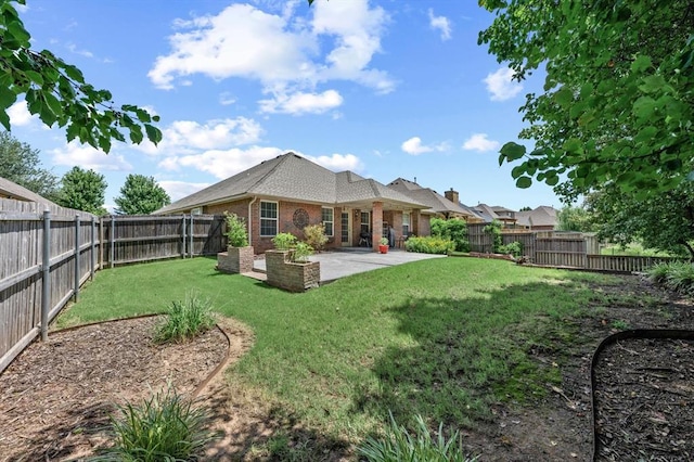 1204 NW 190th Pl, Edmond, OK 73012 - rear view of house with brick siding, a patio area, and a fenced backyard