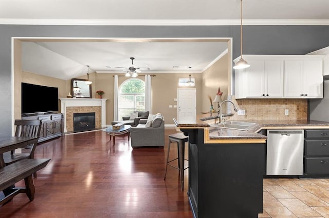 1204 NW 190th Pl, Edmond, OK 73012 - kitchen featuring stainless steel dishwasher, a breakfast bar, white cabinetry, a ceiling fan, and backsplash