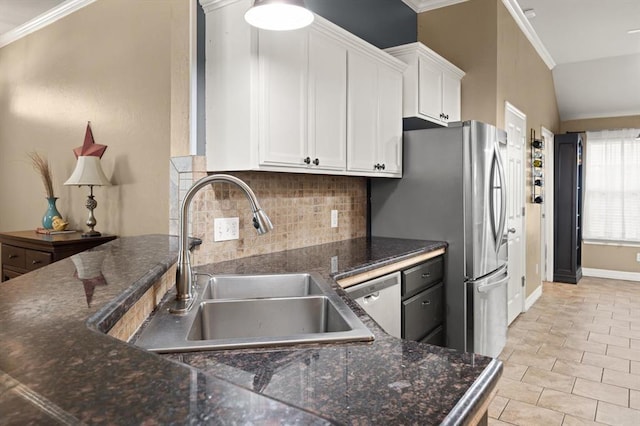 1204 NW 190th Pl, Edmond, OK 73012 - kitchen featuring tasteful backsplash, appliances with stainless steel finishes, ornamental molding, white cabinetry, and dark stone counters