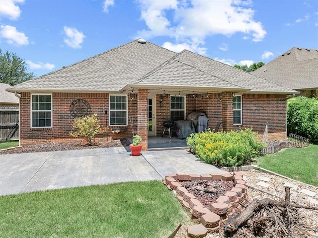 1204 NW 190th Pl, Edmond, OK 73012 - back of property with roof with shingles, brick siding, and a patio area
