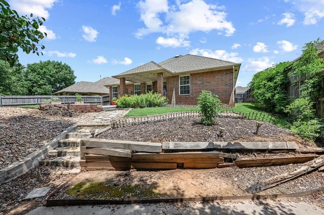 1204 NW 190th Pl, Edmond, OK 73012 - rear view of house with a fenced backyard and brick siding