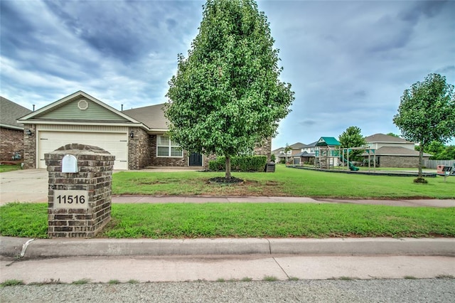 11516 SW 24th St, Yukon, OK 73099 - view of front of house with a garage, a front lawn, concrete driveway, and brick siding