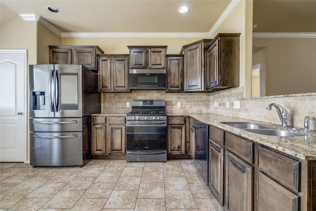 11516 SW 24th St, Yukon, OK 73099 - kitchen featuring appliances with stainless steel finishes, dark brown cabinets, light stone countertops, tasteful backsplash, and ornamental molding