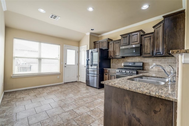 11516 SW 24th St, Yukon, OK 73099 - kitchen featuring appliances with stainless steel finishes, dark brown cabinetry, light stone countertops, tasteful backsplash, and crown molding