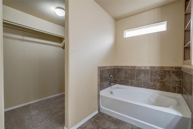 11516 SW 24th St, Yukon, OK 73099 - bathroom featuring a bath and a walk in closet