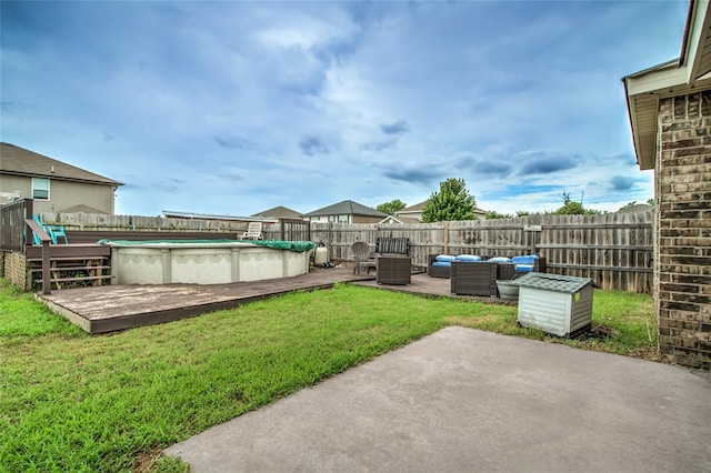 11516 SW 24th St, Yukon, OK 73099 - fenced backyard with an outdoor hangout area, a wooden deck, and a patio