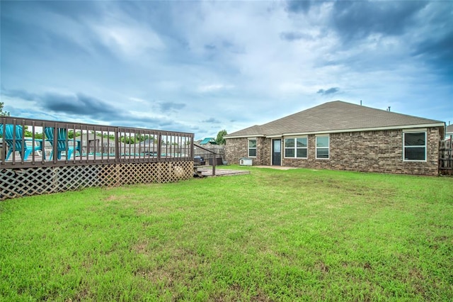 11516 SW 24th St, Yukon, OK 73099 - view of green lawn with a wooden deck