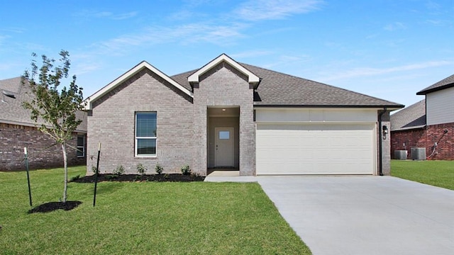 10200 NW 28th Ter, Yukon, OK 73099 - view of front of home featuring driveway, brick siding, a garage, and a front lawn