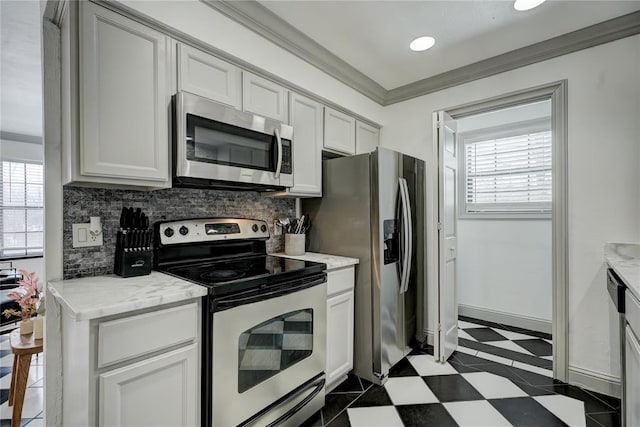4400 Hemingway Dr Unit 259, Oklahoma City, OK 73118 - kitchen featuring stainless steel appliances, backsplash, ornamental molding, white cabinets, and light stone counters