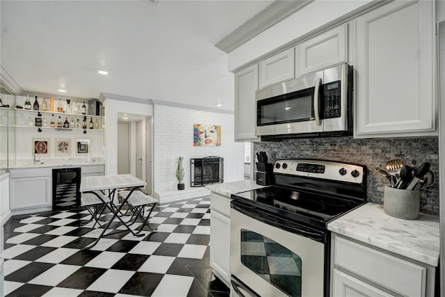 4400 Hemingway Dr Unit 259, Oklahoma City, OK 73118 - kitchen with stainless steel appliances, dark flooring, tasteful backsplash, white cabinets, and recessed lighting
