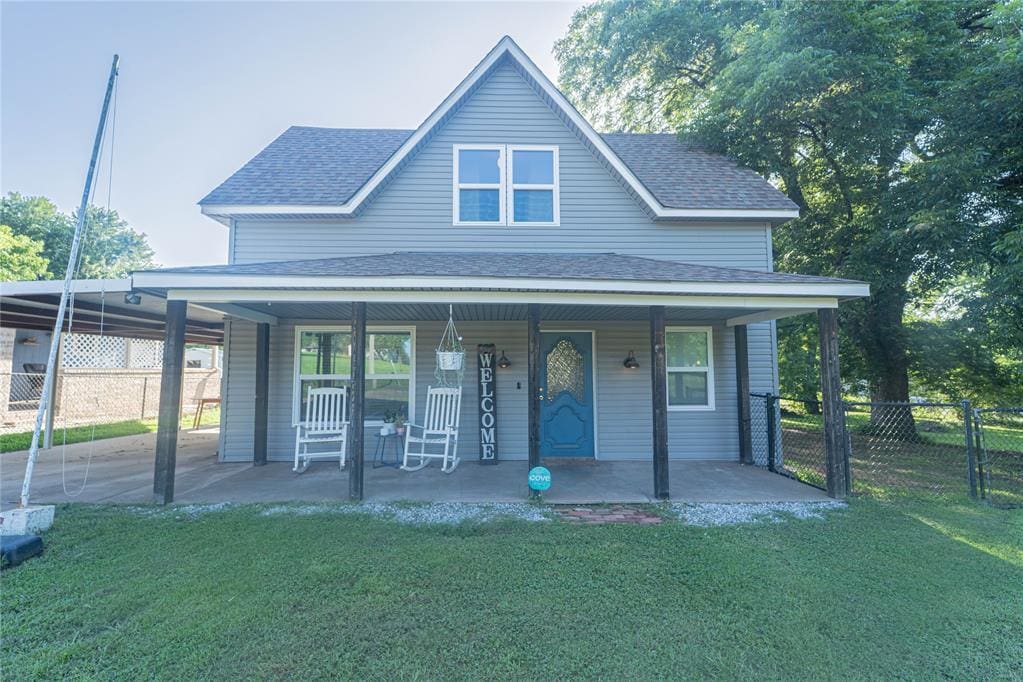 1705 Tim Holt Dr, Harrah, OK 73045 - view of front of property with a shingled roof, a porch, and an attached carport