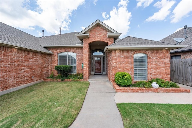 541 SW 154th Ct, Oklahoma City, OK 73170 - view of exterior entry with roof with shingles and brick siding