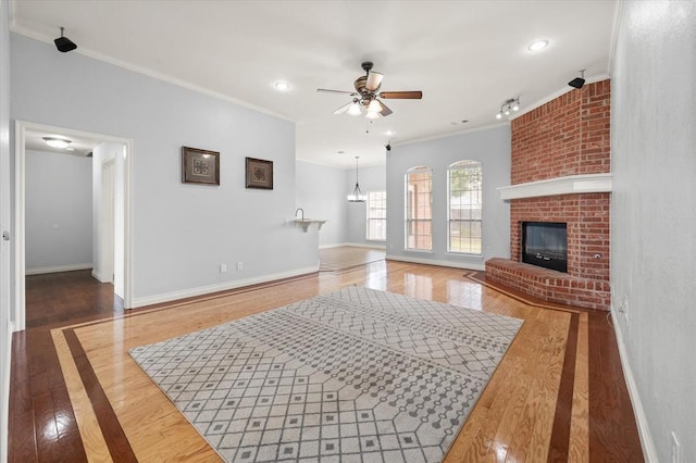 541 SW 154th Ct, Oklahoma City, OK 73170 - living area with ceiling fan, crown molding, a fireplace, wood finished floors, and recessed lighting