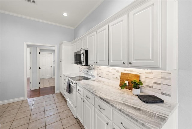 541 SW 154th Ct, Oklahoma City, OK 73170 - kitchen featuring white electric range, stainless steel microwave, white cabinetry, crown molding, and backsplash