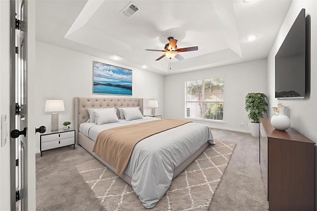 541 SW 154th Ct, Oklahoma City, OK 73170 - bedroom with a tray ceiling, light colored carpet, recessed lighting, and ceiling fan