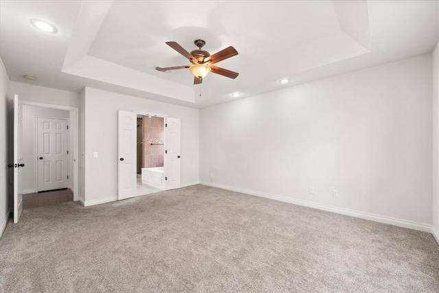 541 SW 154th Ct, Oklahoma City, OK 73170 - unfurnished bedroom featuring carpet flooring, a raised ceiling, recessed lighting, ensuite bathroom, and a ceiling fan