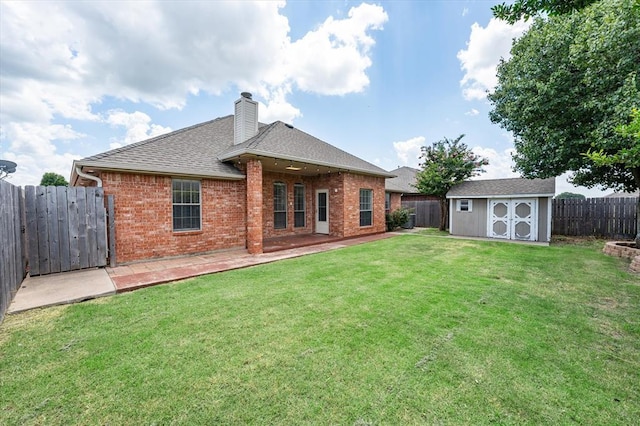 541 SW 154th Ct, Oklahoma City, OK 73170 - back of property with brick siding, a fenced backyard, a chimney, and a storage shed