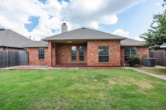 541 SW 154th Ct, Oklahoma City, OK 73170 - back of property featuring a patio area, a chimney, brick siding, and a shingled roof