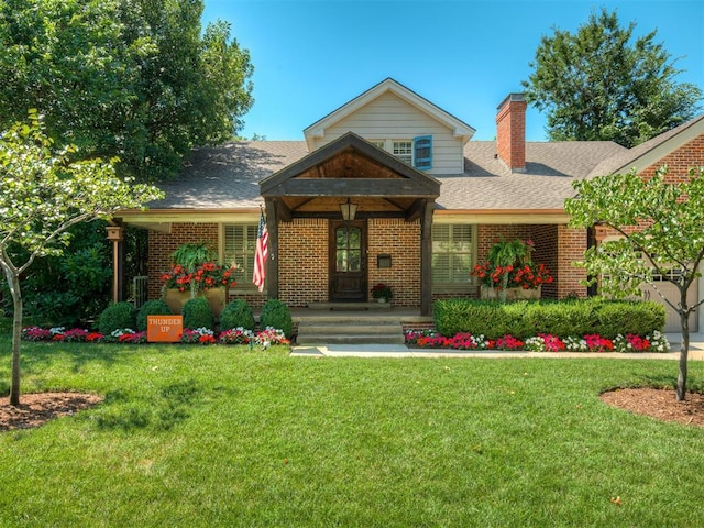 1718 Guilford Ln, Oklahoma City, OK 73120 - view of front of house with brick siding, a chimney, a front yard, and roof with shingles