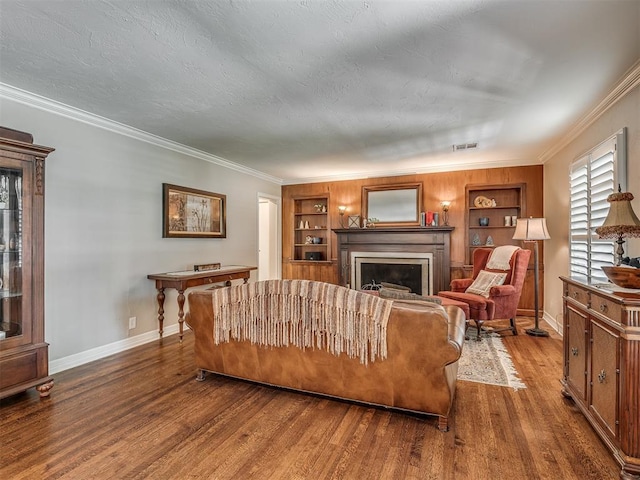 1718 Guilford Ln, Oklahoma City, OK 73120 - living area featuring a fireplace, wood finished floors, built in features, and ornamental molding
