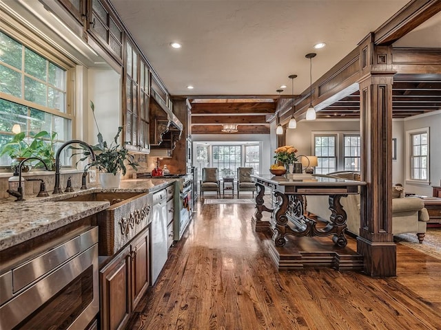 1718 Guilford Ln, Oklahoma City, OK 73120 - kitchen featuring open floor plan, stainless steel microwave, dishwashing machine, dark wood finished floors, and recessed lighting