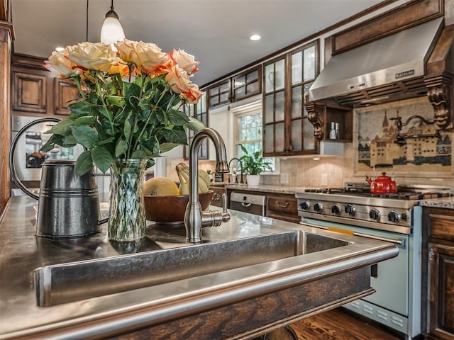 1718 Guilford Ln, Oklahoma City, OK 73120 - kitchen with appliances with stainless steel finishes, extractor fan, decorative backsplash, dark brown cabinetry, and recessed lighting