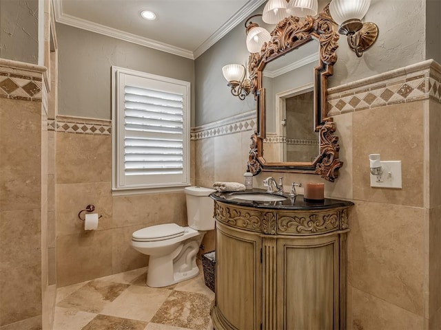 1718 Guilford Ln, Oklahoma City, OK 73120 - bathroom with tile walls, vanity, ornamental molding, and wainscoting